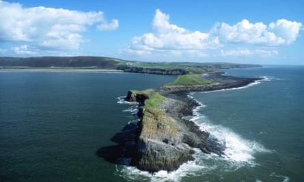 Worm’s Head and Rhossili Bay beach aerial view Gower Peninsula Swansea County South Wales UK.